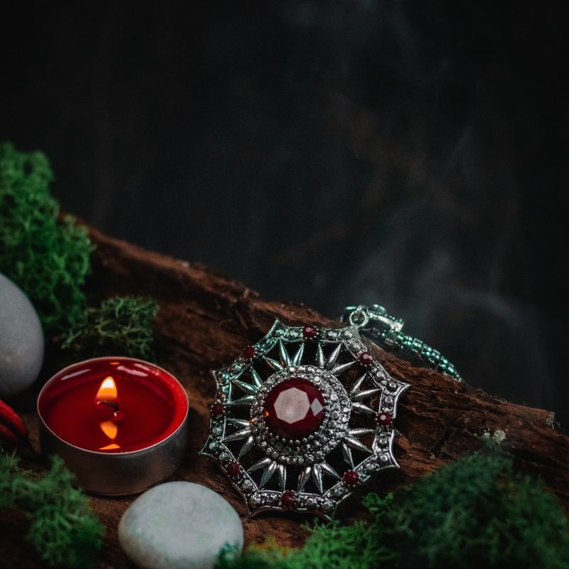 ritual-amulet-green-moss-and-stones-in-the-bark-of-a-tree-on-a-black-background--q65q3iolqa2ua93nv2153y46mucrlvz6ez4emowfnk